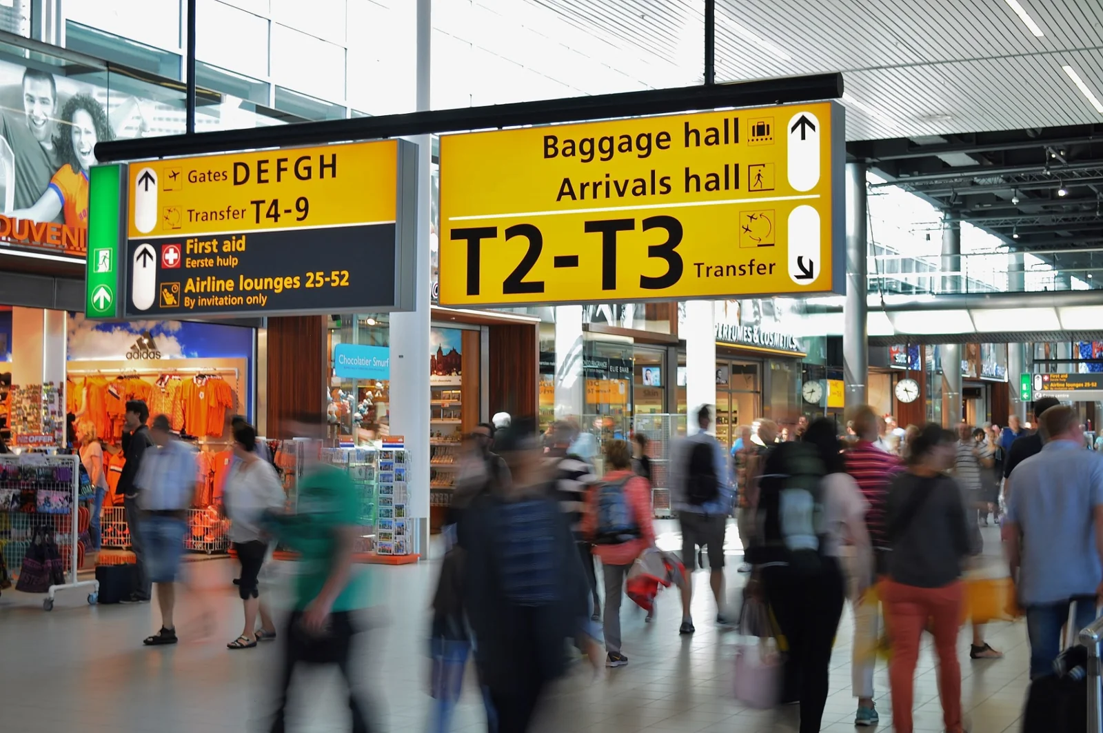 Travellers moving through a busy airport terminal